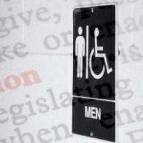 Men sign outside of bathroom