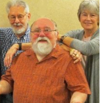 Two Gray haired men and a gray haired lady posing and smiling