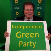 Man holding sign that says Independent Green Party