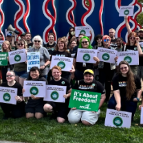 CMA workers with signs posing outside