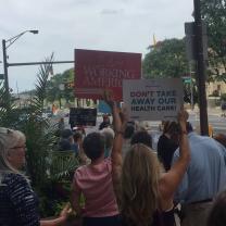 People holding signs about health care
