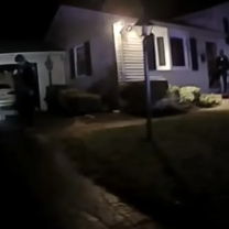 Police outside a house at night