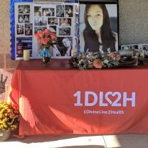 A table with memorial items from Bobbie Simpson and a table with the logo from 1DIVINELINE2HEALTH