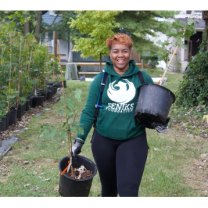Woman with trees in pots