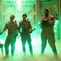 The three women in uniforms with ghost busting guns and foggy stuff around their feet