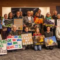 People posing with signs