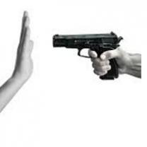 Someone pointing a gun with a side view and someone holding up their hand in front of it