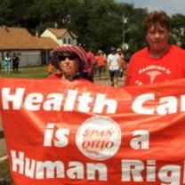 People marching holding sign