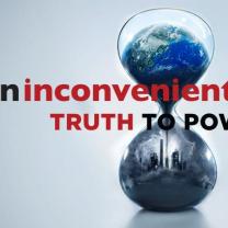 An hourglass with the earth on top and a dark gray skyline on the bottom with the words an inconvenient truth to power