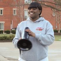 Young black woman with bullhorn outside at rally