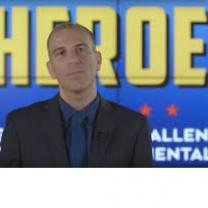 White balding guy against blue background with yellow words saying Heroes