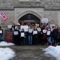 Students holding signs