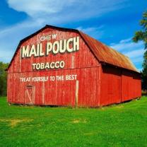 Red barn with Mailpouch written on it
