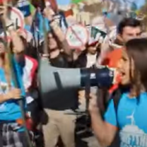 People marching, girl shouting into megaphone