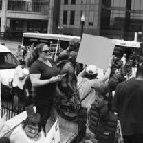 Black and white photo of people holding signs and protesting