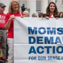 Women holding Moms Demand Action banner
