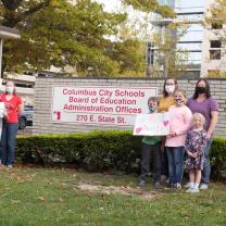 People posing in protest outside Cols City Schools