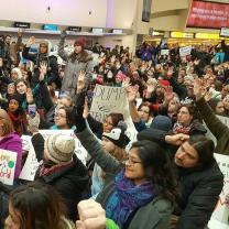 Lots of people holding signs at a rally