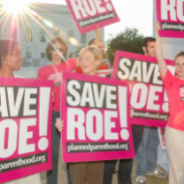 People holding Save Roe signs