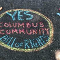 Chalk words on ground Yes Columbus Community Bill of Rights
