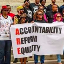 People outside holding banner