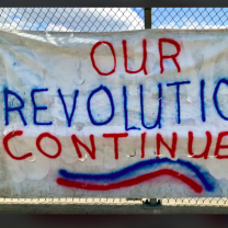 Sign saying Our Revolution Continues