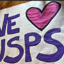 Sign saying We Love USPS