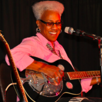 Gaye Adegbalola playing a guitar