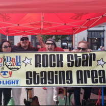 People holding sign saying Rock Star Staging Area