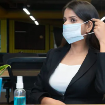 Woman wearing mask in office