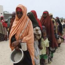 Somalian women in Somalia wearing headresses standing in line waiting for food