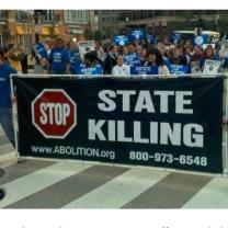 People marching with sign Stop State Killing