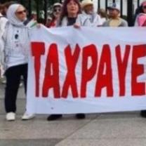 People holding Taxpayers Aganst Genocide banner