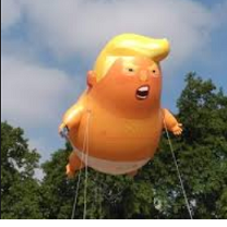 Big inflated balloon shaped like a fat baby in a diaper with orange skin and large yellow hair flowing at the top with his mouth open held up high in the air by strings