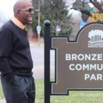 Willis Brown next to Park sign