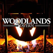 Fire in stove behind words Woodlands Tavern