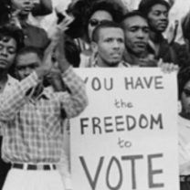People from 60s with sign saying You Have the Freedom to Vote