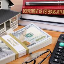 Money, house, book titled Dept of Veterans Affairs