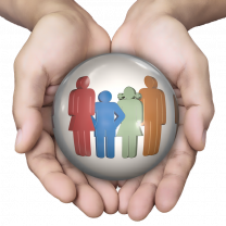 Two hands holding images of a family in a circle