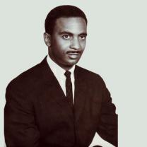 Black and white photo of young black man in a suit