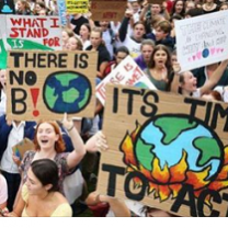 Lots of people outside from a view above all holding signs like There is no planet B and It's time to Act