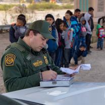 Border patrol and line of immigrants