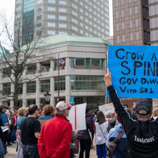 Protest with sign Grow a Spine Gov DeWine