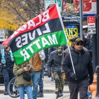 Marcher with Black Lives Matter flag