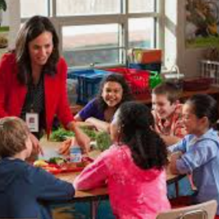 Young student with teacher in classroom