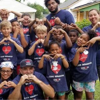 Kids making heart signs with their hands