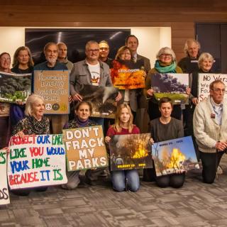 People posing with signs