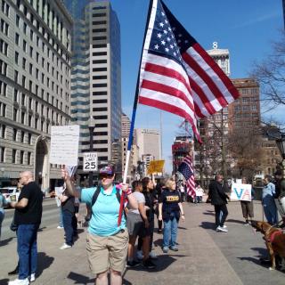 Protesters and one holding US flag