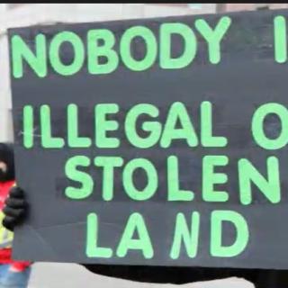 Sign saying nobody is illegal on stolen land