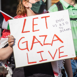 Student holding sign saying Let Gaza Live